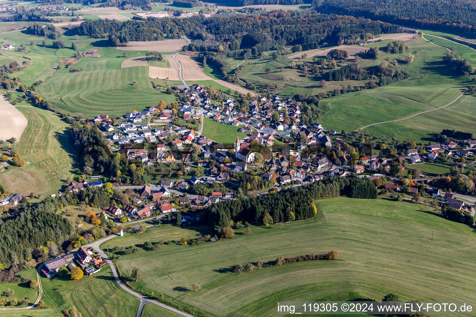 Aerial view of Agricultural land and field borders surround the settlement area of the village in Hoppetenzell in the state Baden-Wurttemberg, Germany