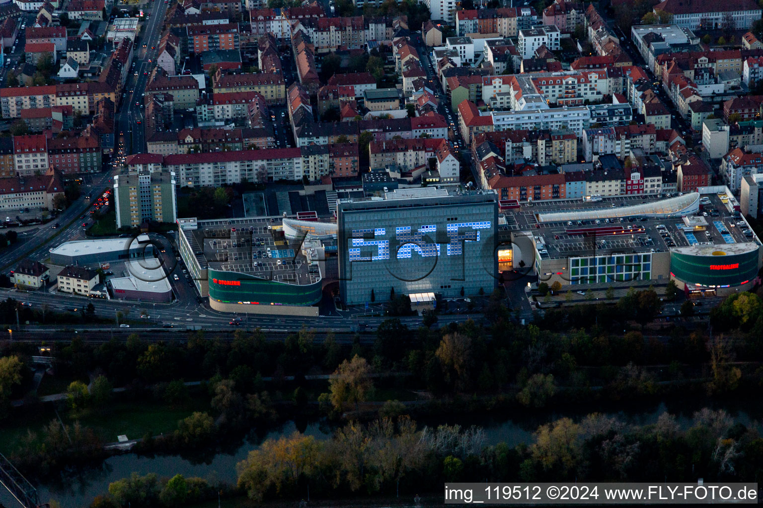 Building of the shopping center Stadtgalerie Schweinfurt and illumated SKF Hochhaus at dawn in Schweinfurt in the state Bavaria, Germany