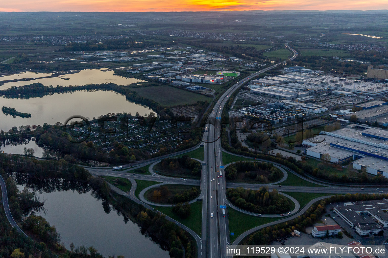 Aerial view of Sunset traffic flow at the intersection- motorway A 7 Exit Centre in Schweinfurt in the state Bavaria, Germany