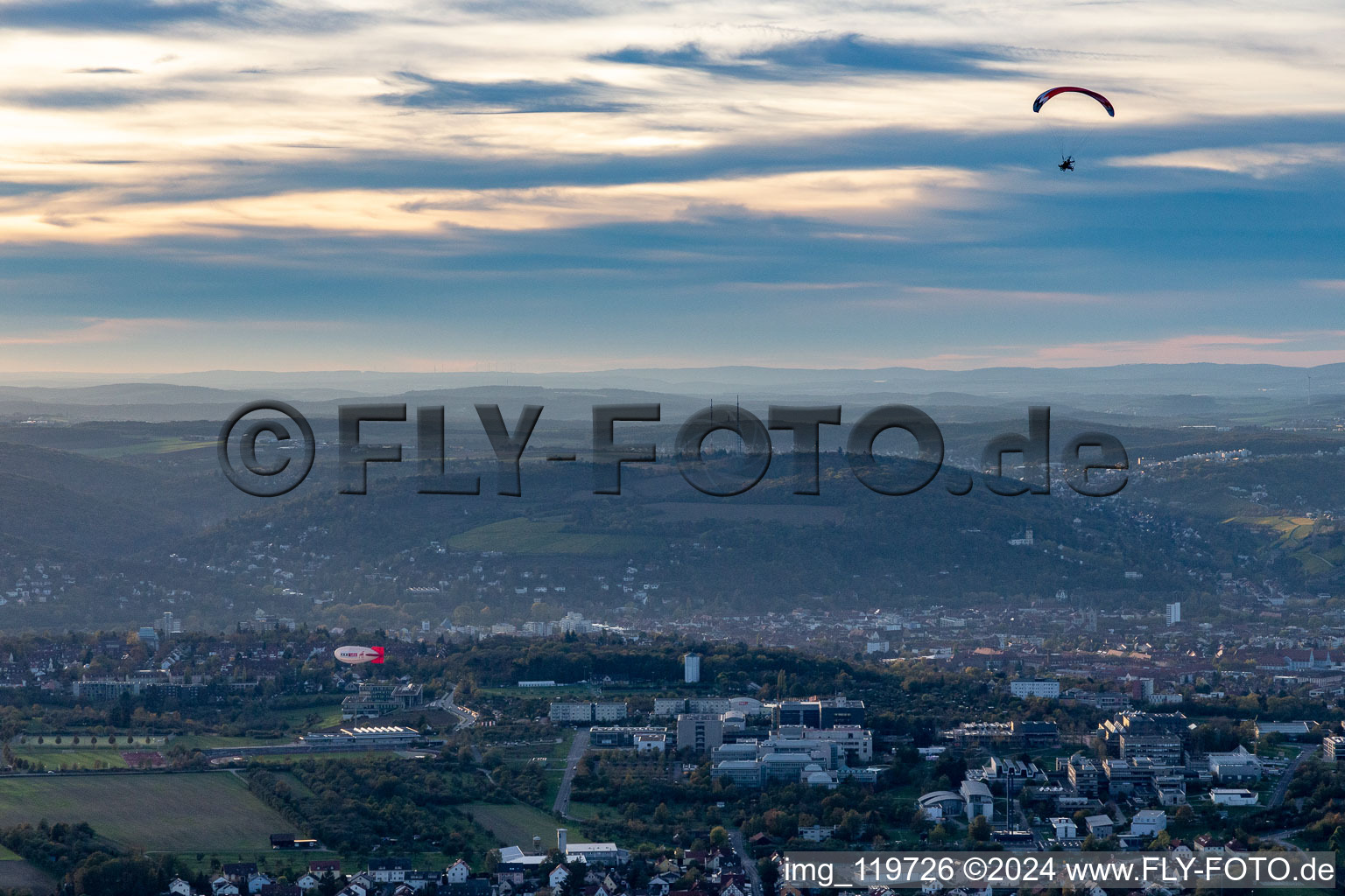 Zeppelin and paraglider over Galgenberg in Gerbrunn in the state Bavaria, Germany