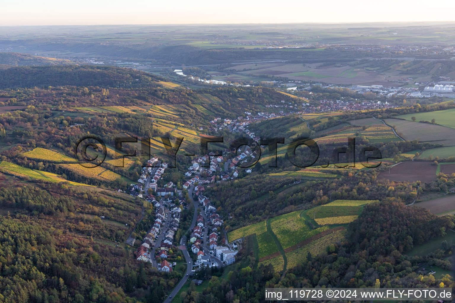 Location view of the streets and houses of residential areas in the valley landscape surrounded by vine yards in Randersacker in the state Bavaria, Germany