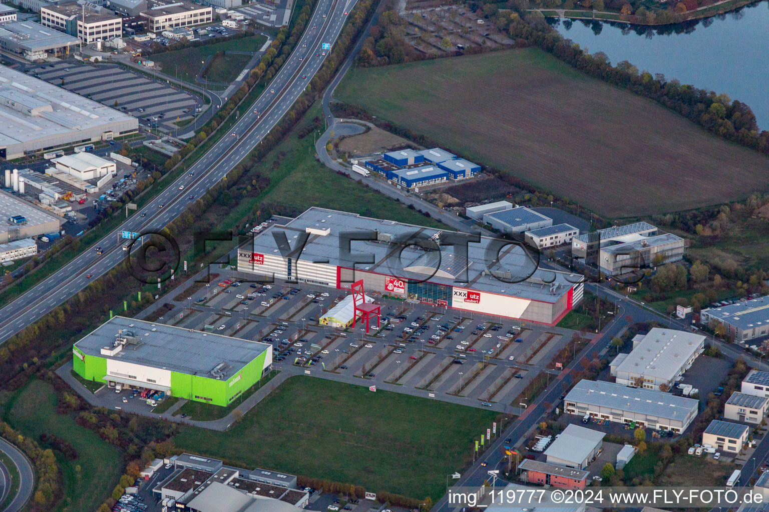 Aerial view of XXXL-sized chair on the parkinkg of the furniture market XXXLutz Neubert Schweinfurt in Gewebegebiet Maintal in Schweinfurt in the state Bavaria, Germany