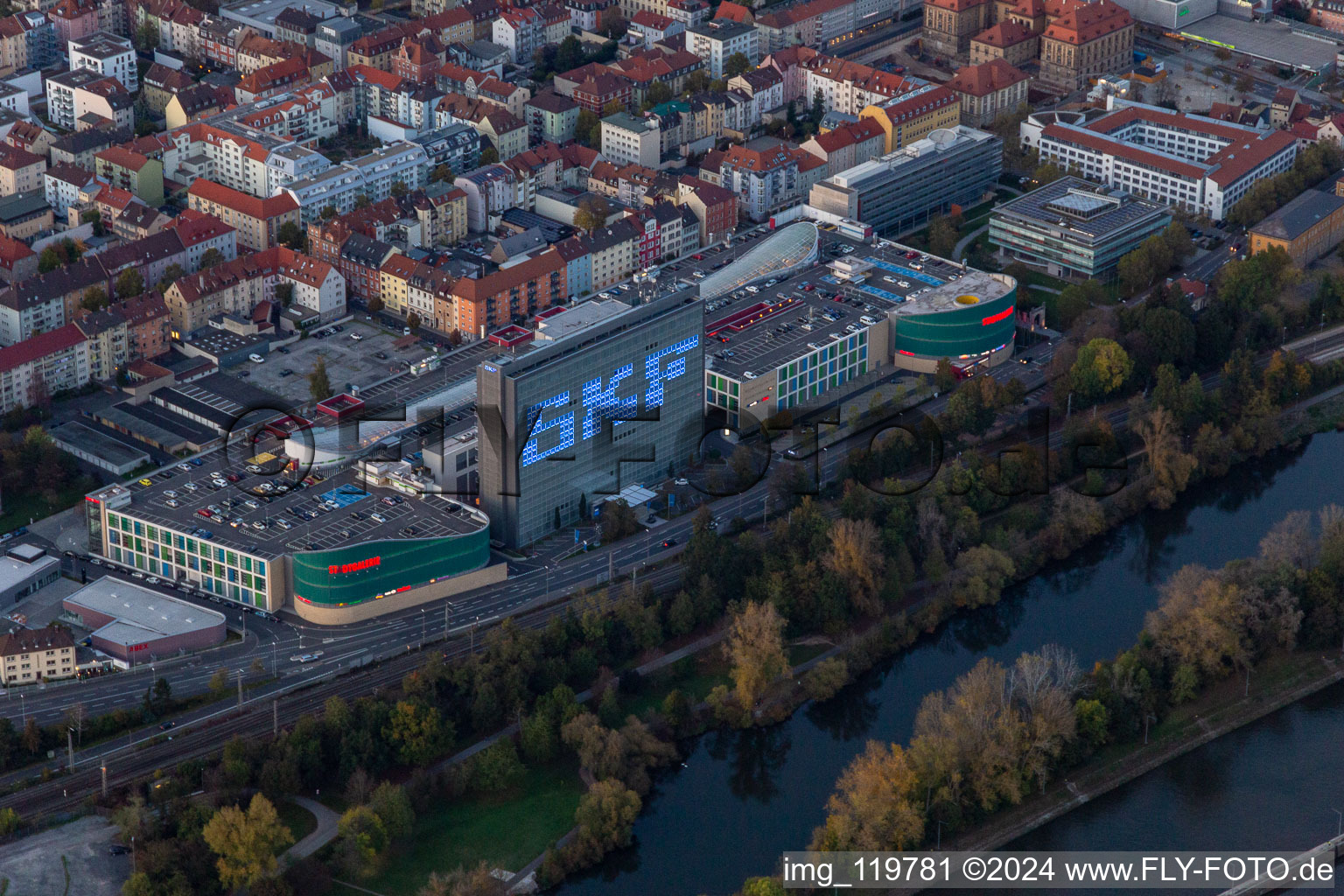 Aerial view of Building of the shopping center Stadtgalerie Schweinfurt and illumated SKF Hochhaus at dawn in Schweinfurt in the state Bavaria, Germany