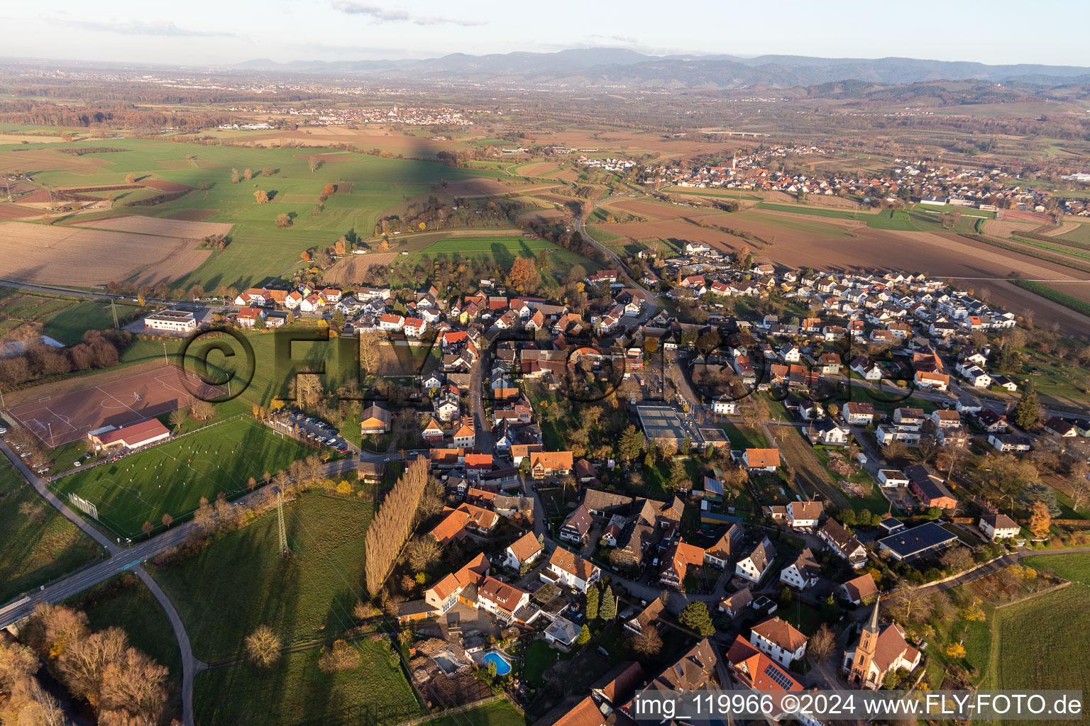 Village view on the edge of agricultural fields and land and sporting fields in the district Buehl in Offenburg in the state Baden-Wurttemberg, Germany