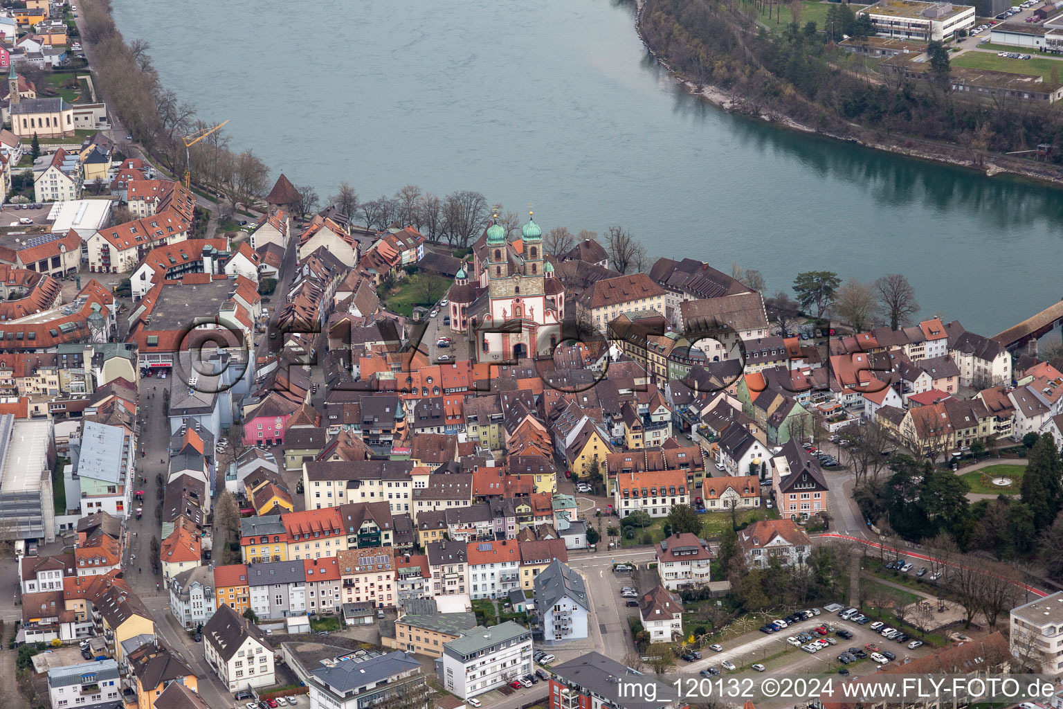 Church building St. Fridolin in the Old Town- center of downtown in Bad Saeckingen in the state Baden-Wurttemberg. The historic wooden bridge over the river Rhine connects Germany with Switzerland and Novartis Stein