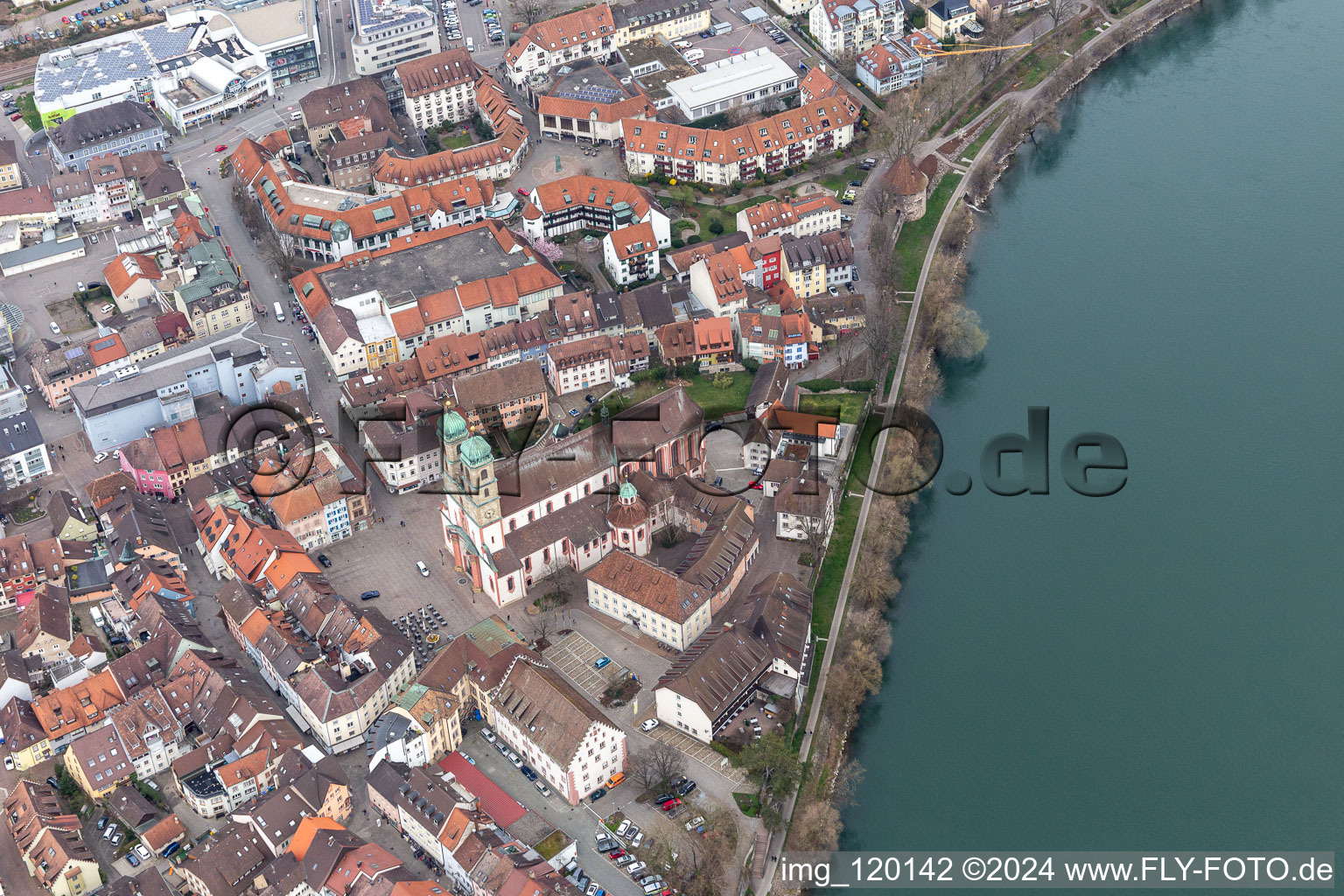 Aerial view of Church building St. Fridolin in the Old Town- center of downtown in Bad Saeckingen in the state Baden-Wurttemberg. The historic wooden bridge over the river Rhine connects Germany with Switzerland and Novartis Stein