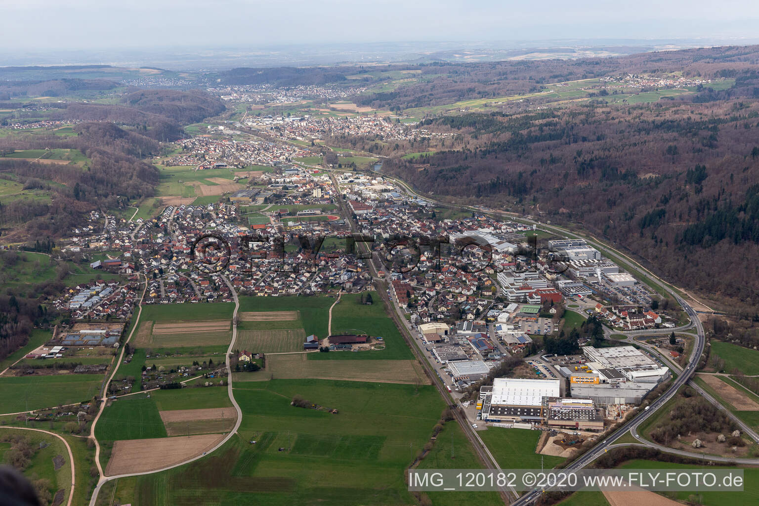 Location view of the streets and houses of residential areas in the valley landscape of the Wiese river surrounded by mountains in Maulburg in the state Baden-Wuerttemberg, Germany