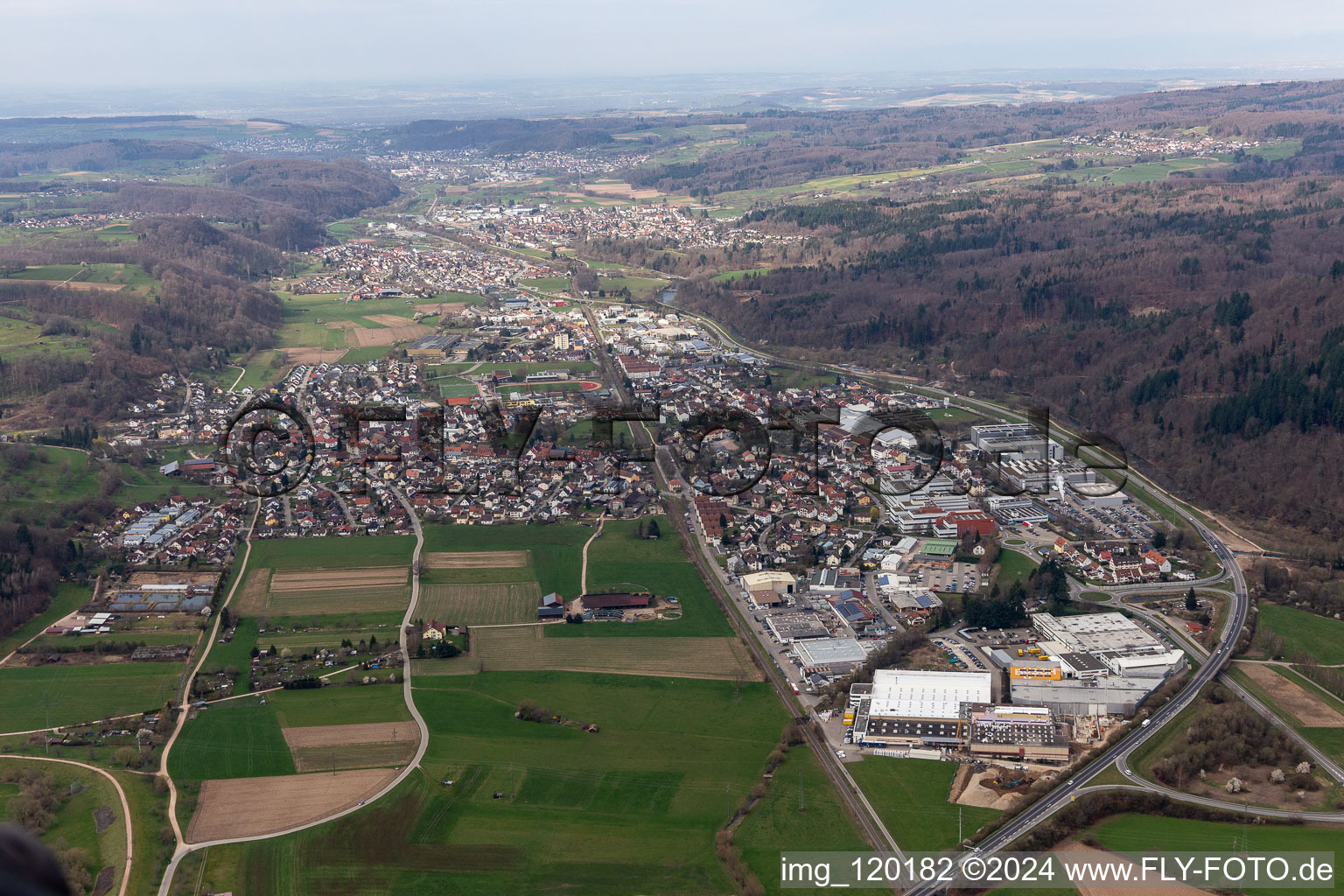 Location view of the streets and houses of residential areas in the valley landscape of the Wiese river surrounded by mountains in Maulburg in the state Baden-Wuerttemberg, Germany