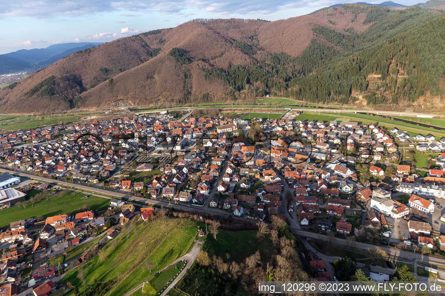 Aerial view of Location view of the streets and houses of residential areas in the valley of the Kinzig landscape surrounded by mountains in Steinach in the state Baden-Wuerttemberg, Germany