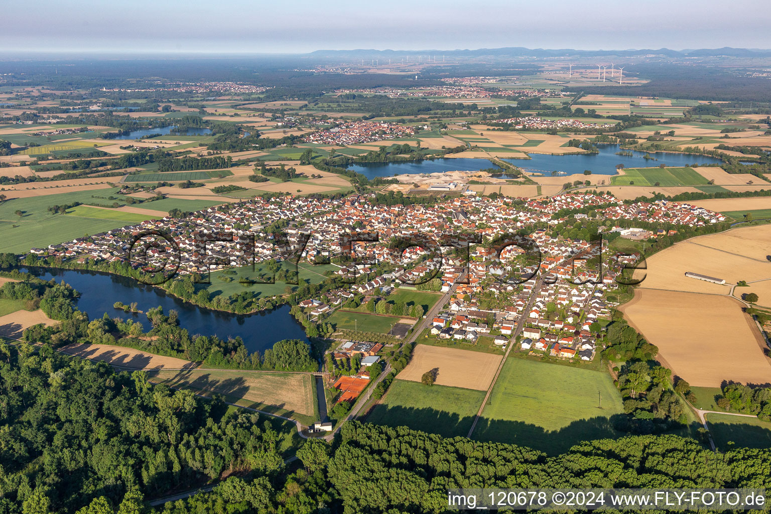 Village - view on the edge of agricultural fields and farmland in Leimersheim in the state Rhineland-Palatinate