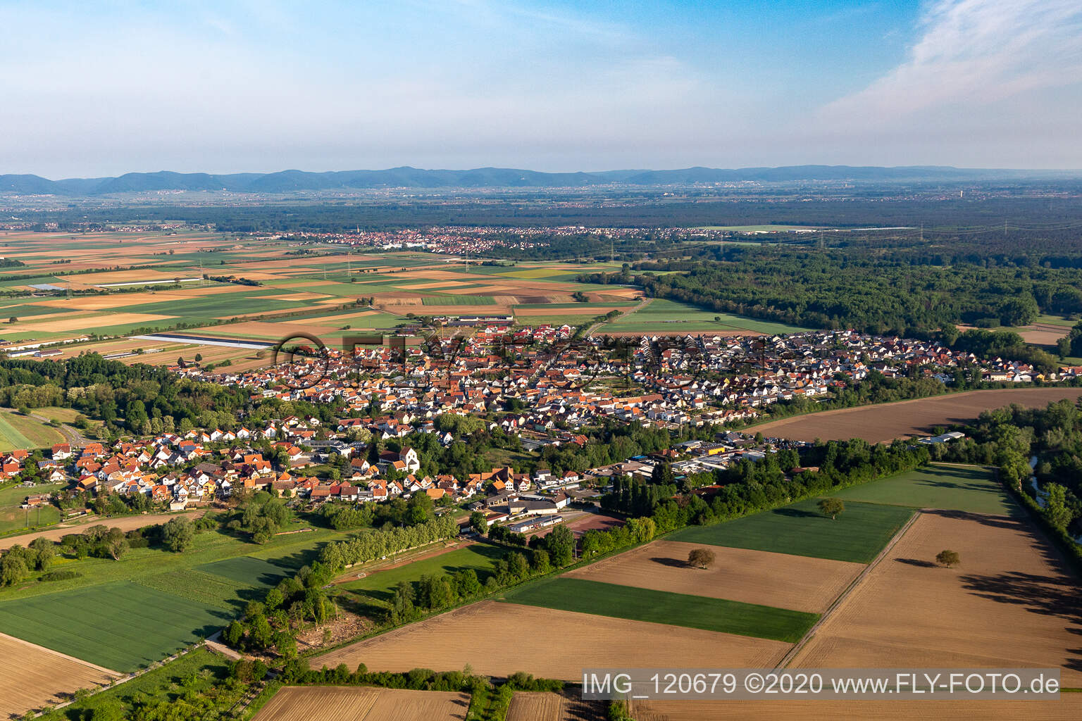 Village - view on the edge of agricultural fields and farmland in Hoerdt in the state Rhineland-Palatinate