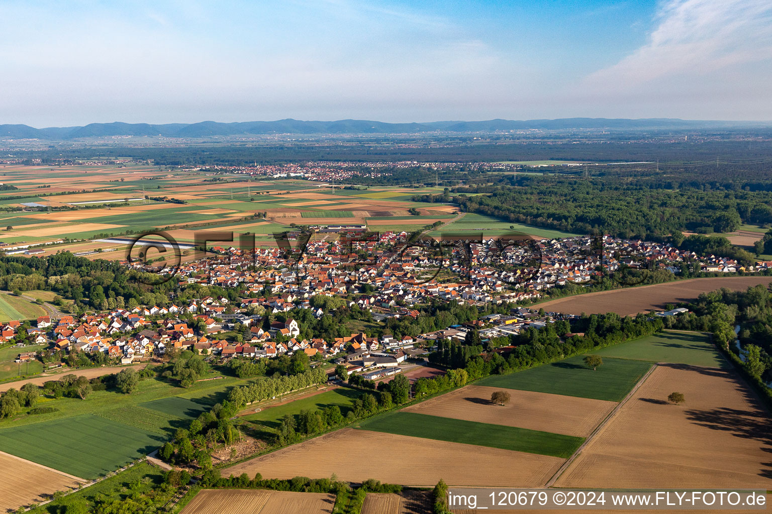 Village - view on the edge of agricultural fields and farmland in Hoerdt in the state Rhineland-Palatinate