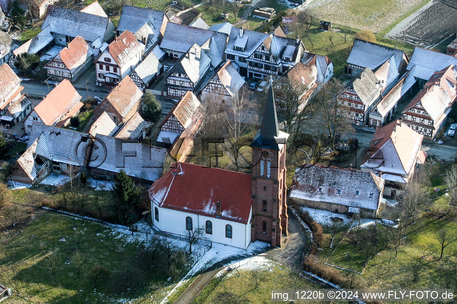 Wintry snowy protestantic Church building in the village of in Hunspach in Grand Est, France