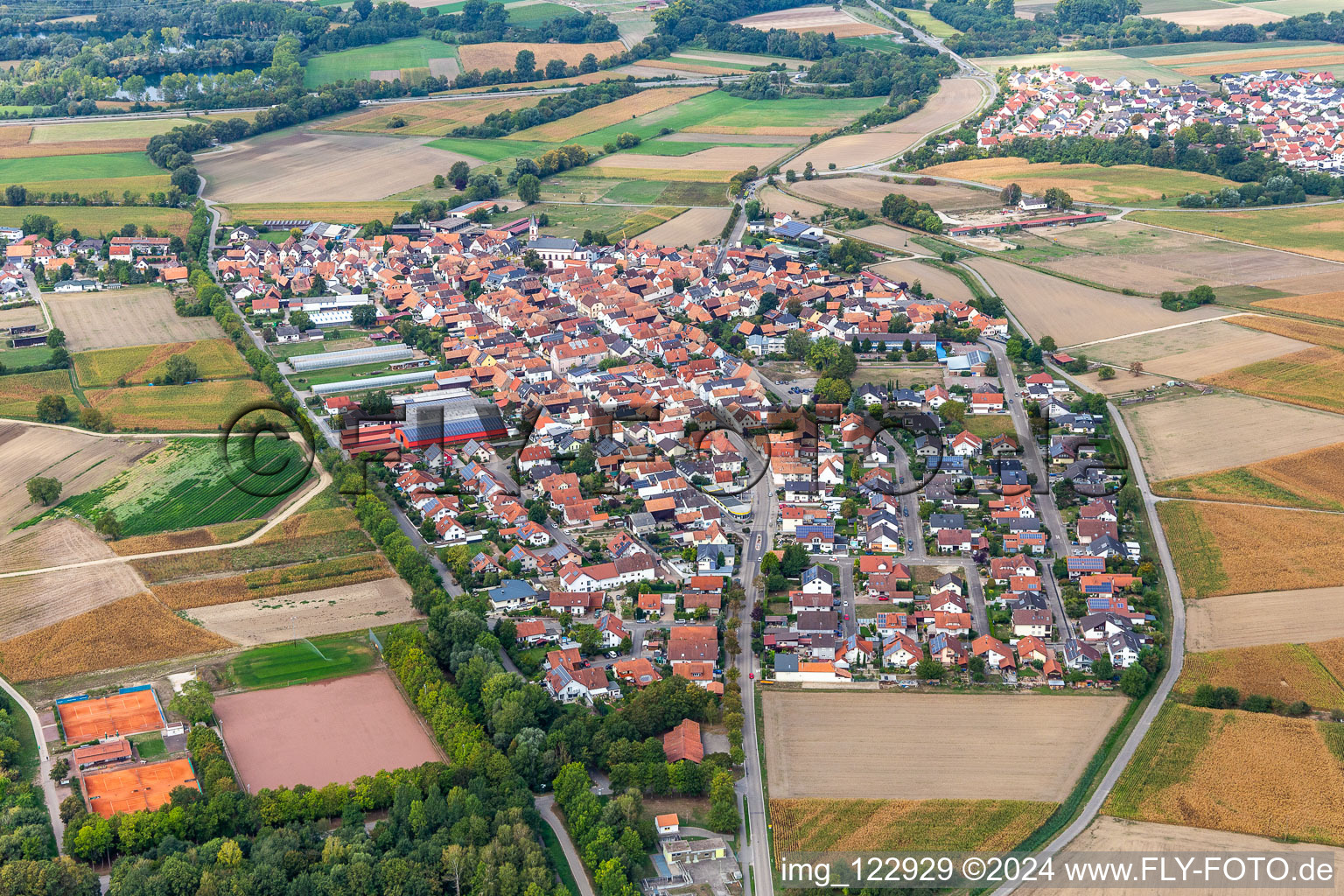 Village - view on the edge of agricultural fields and farmland in the district Hardtwald in Neupotz in the state Rhineland-Palatinate