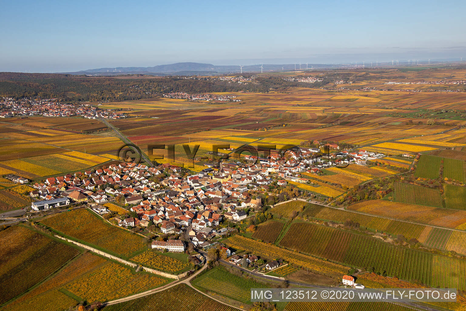 Autumnal discolored vegetation view village - view on the edge of wine yards in Herxheim am Berg in the state Rhineland-Palatinate, Germany