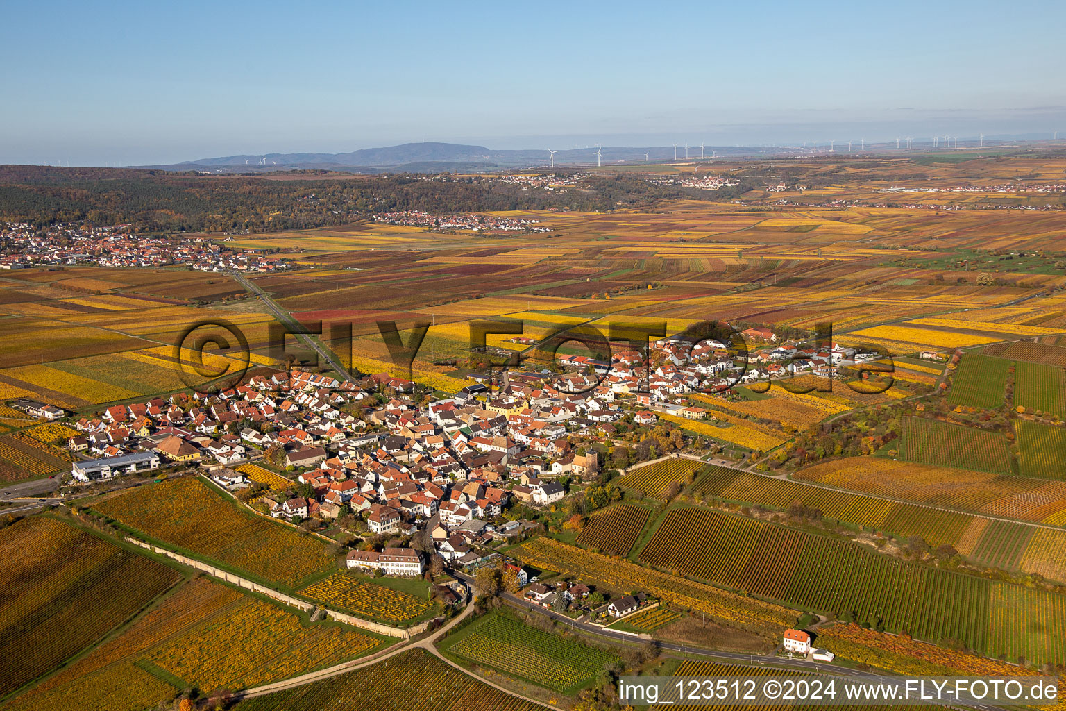 Autumnal discolored vegetation view village - view on the edge of wine yards in Herxheim am Berg in the state Rhineland-Palatinate, Germany