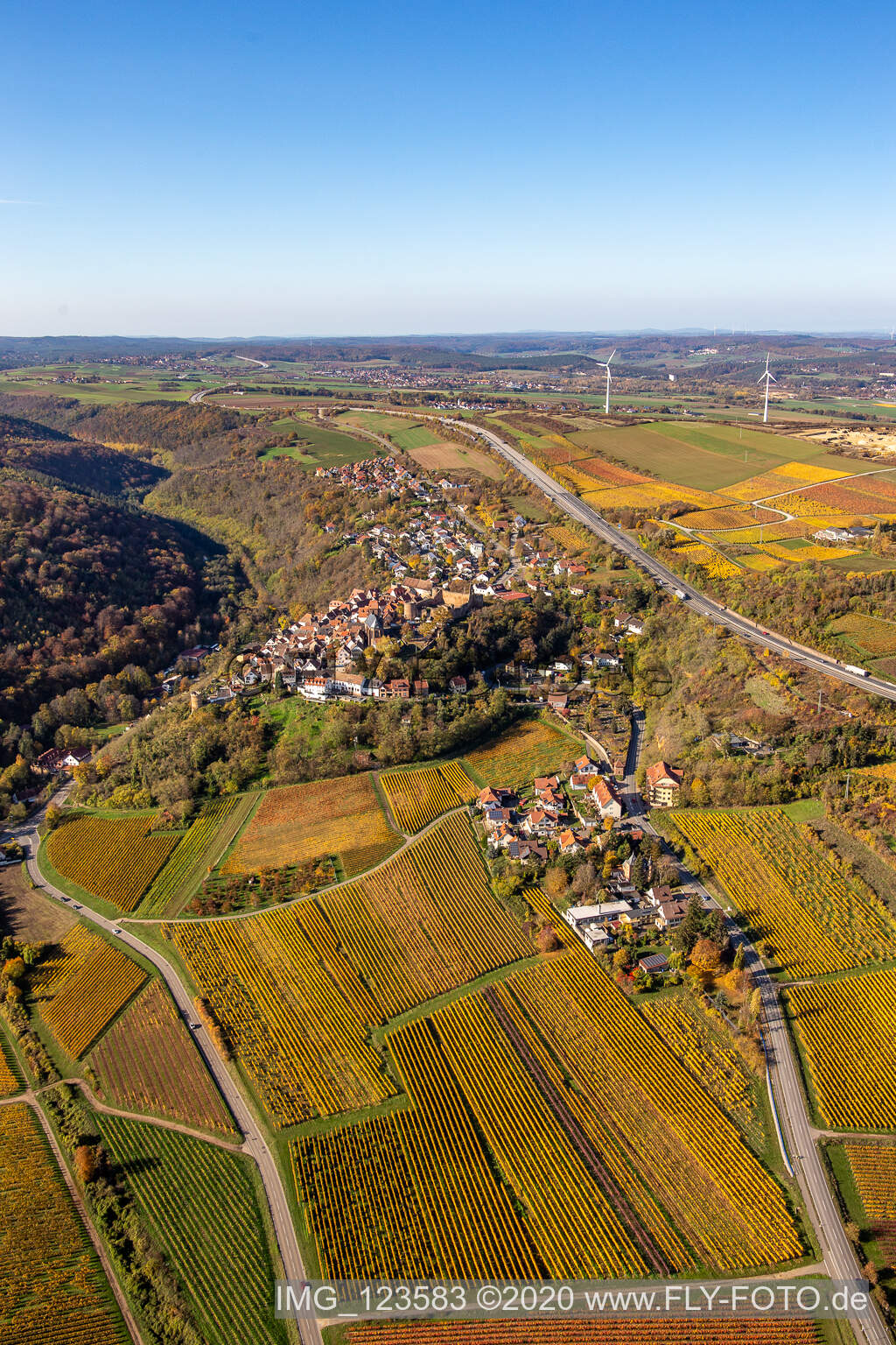 Oblique view of Autumnal discolored vegetation view town center on the edge of vineyards and wineries in the wine-growing area in Neuleiningen in the state Rhineland-Palatinate, Germany