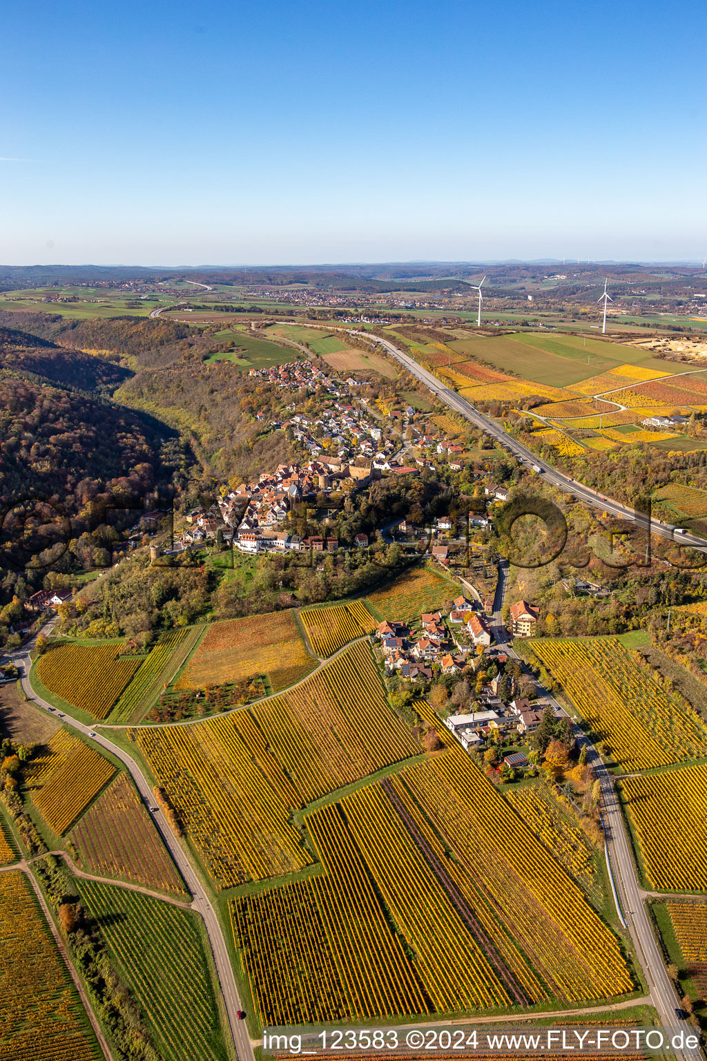 Oblique view of Autumnal discolored vegetation view town center on the edge of vineyards and wineries in the wine-growing area in Neuleiningen in the state Rhineland-Palatinate, Germany