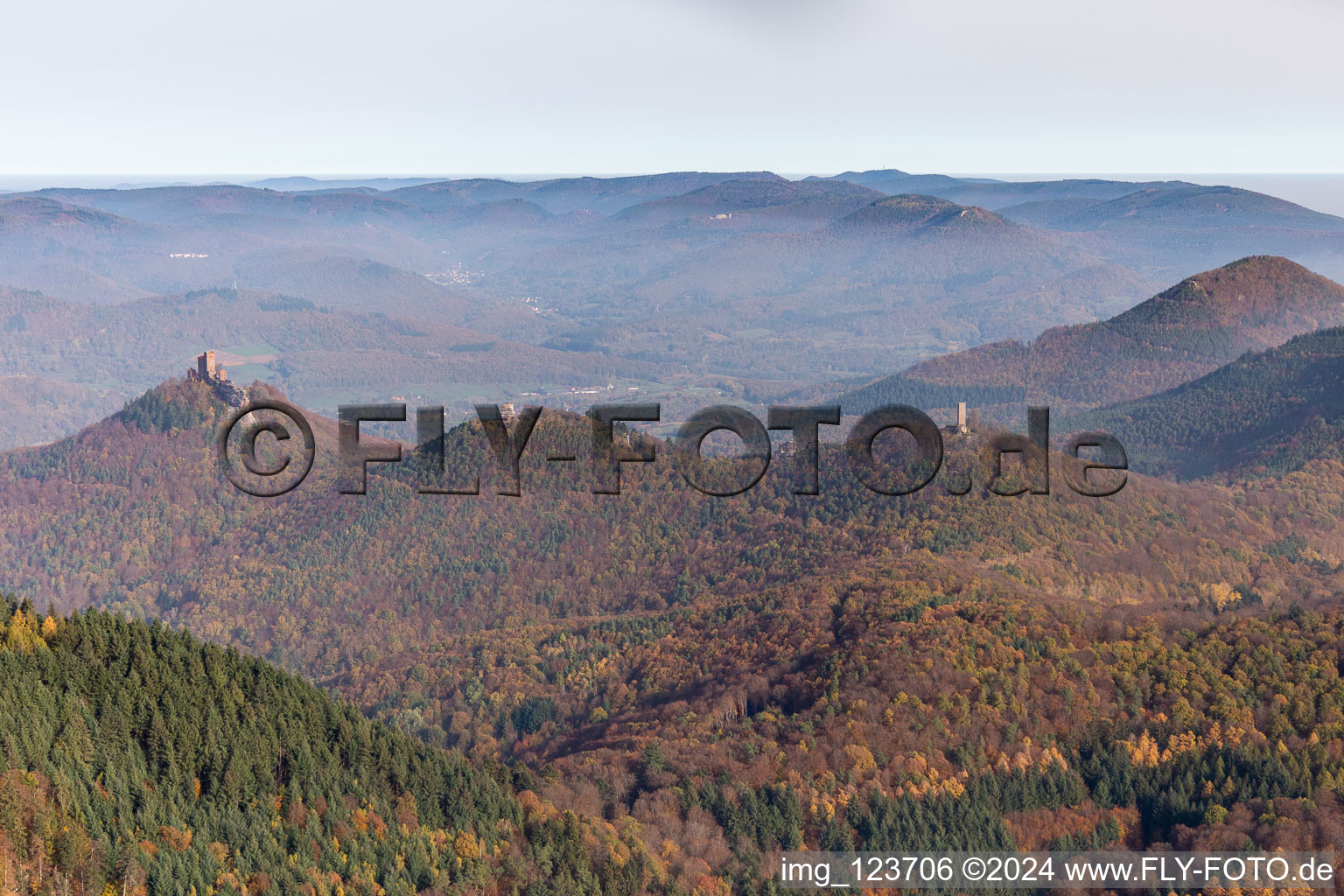 Autumnal discolored vegetation view of castle of the fortresses Trifels, Scharfeneck and Anebos at sunset in Annweiler am Trifels in the state Rhineland-Palatinate, Germany