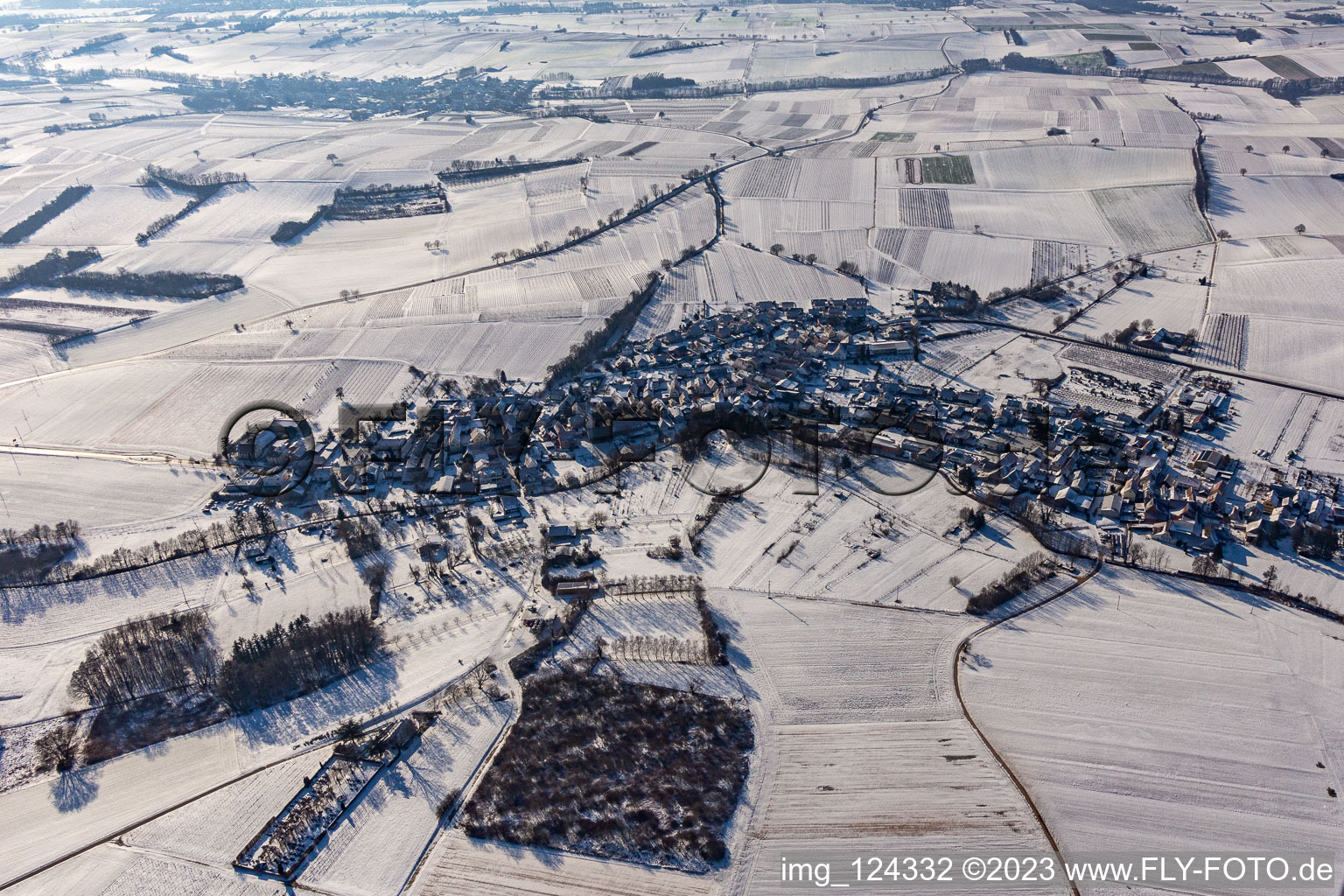 Wintry snowy village - view on the edge of agricultural fields and farmland in Oberhausen in the state Rhineland-Palatinate, Germany