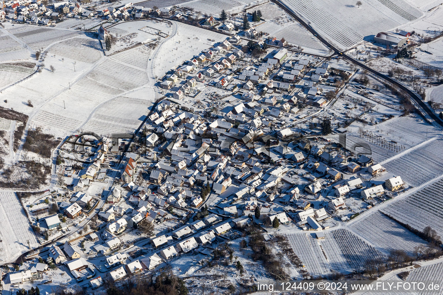 Aerial view of Wintry snowy village on the edge of vineyards and wineries in the wine-growing area Suedliche Weinstrasse in Gleishorbach in the state Rhineland-Palatinate, Germany