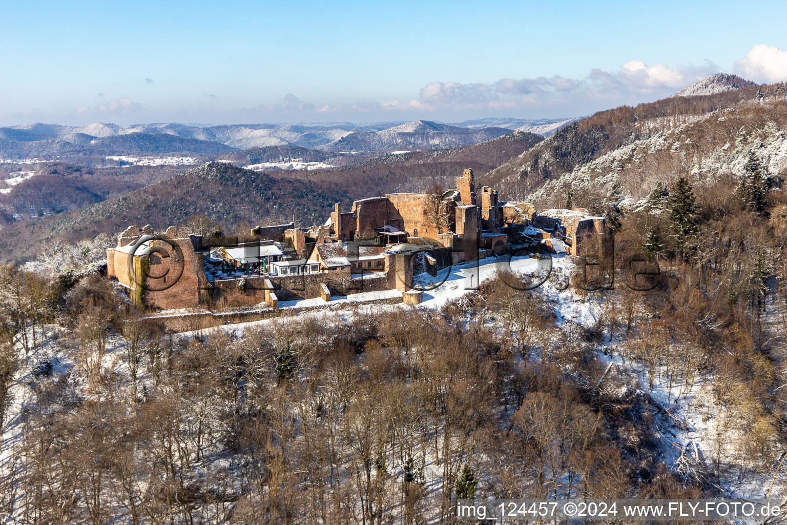 Aerial view of Wintry snowy ruins and vestiges of the former castle and fortress Burgruine Madenburg in Eschbach in the state Rhineland-Palatinate