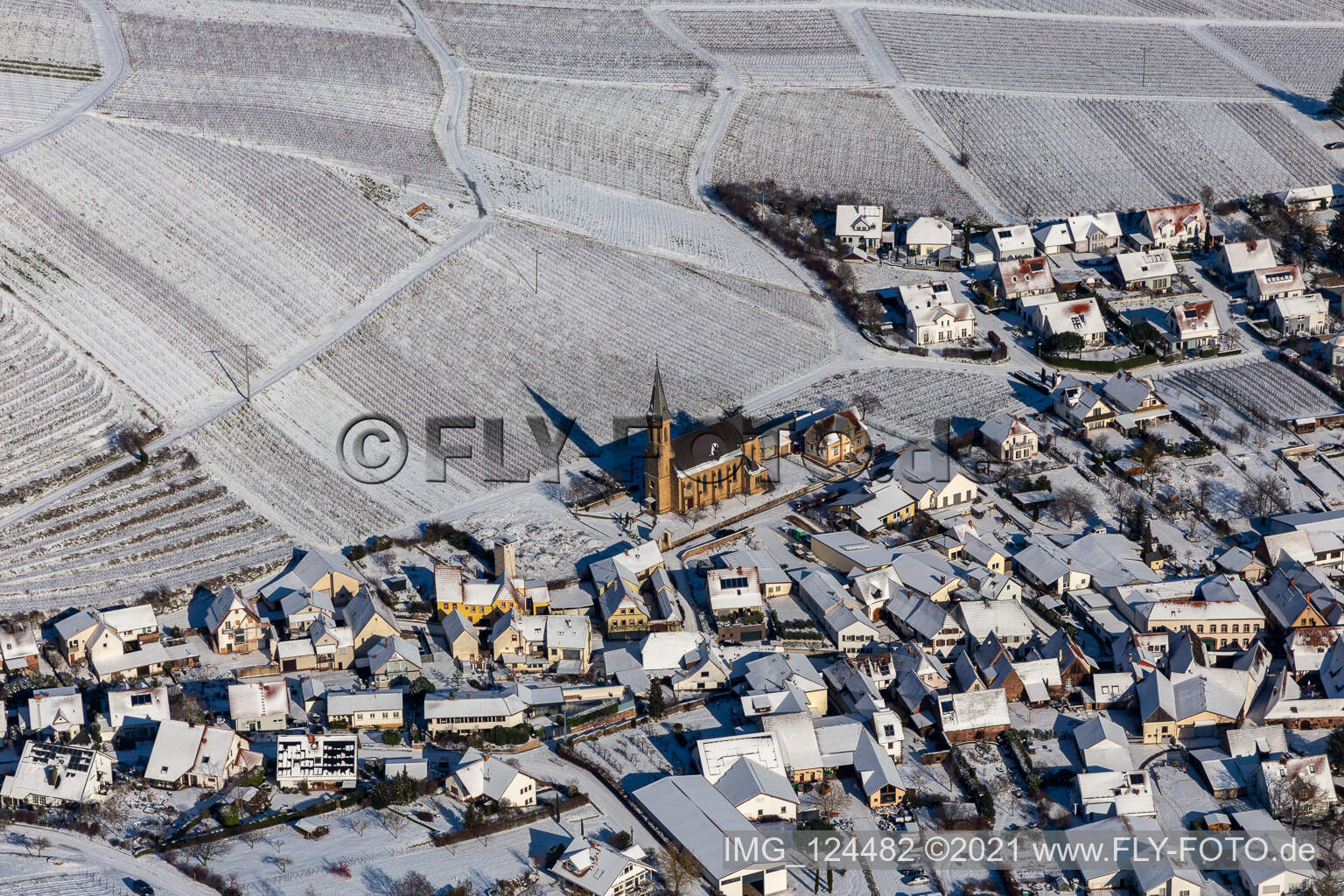 Aerial view of Wintry snowy wine yards surround the settlement area of the village in Birkweiler in the state Rhineland-Palatinate, Germany