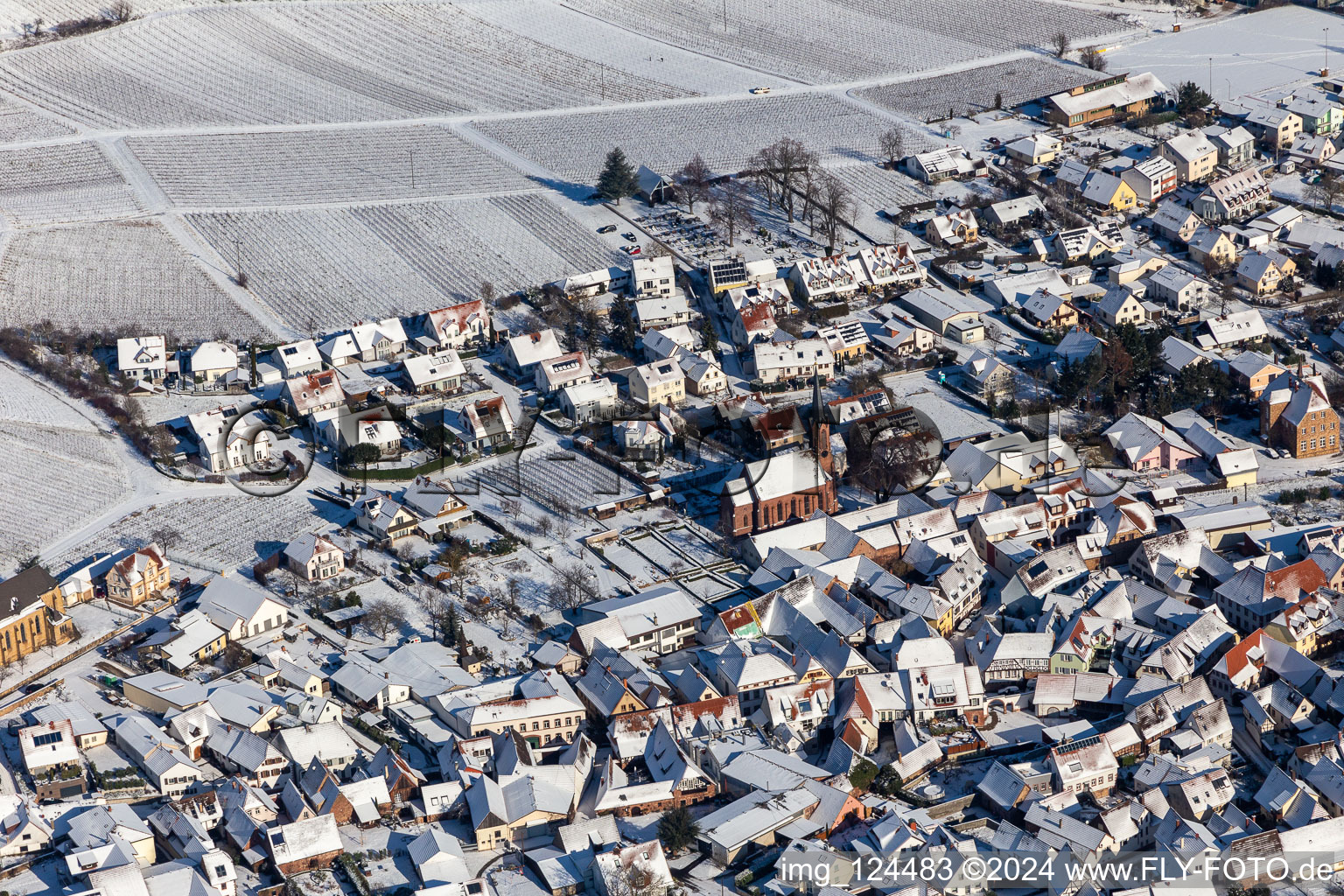 Winter aerial view in the snow of the Protestant church in Birkweiler in the state Rhineland-Palatinate, Germany