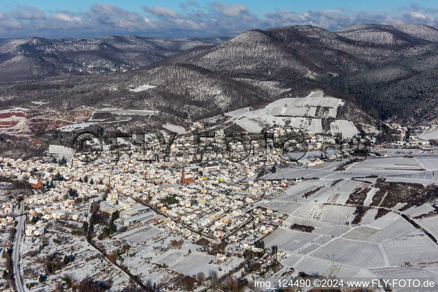 Wintry snowy location view of the streets and houses of residential areas in the Queich valley landscape surrounded by mountains in Albersweiler in the state Rhineland-Palatinate, Germany