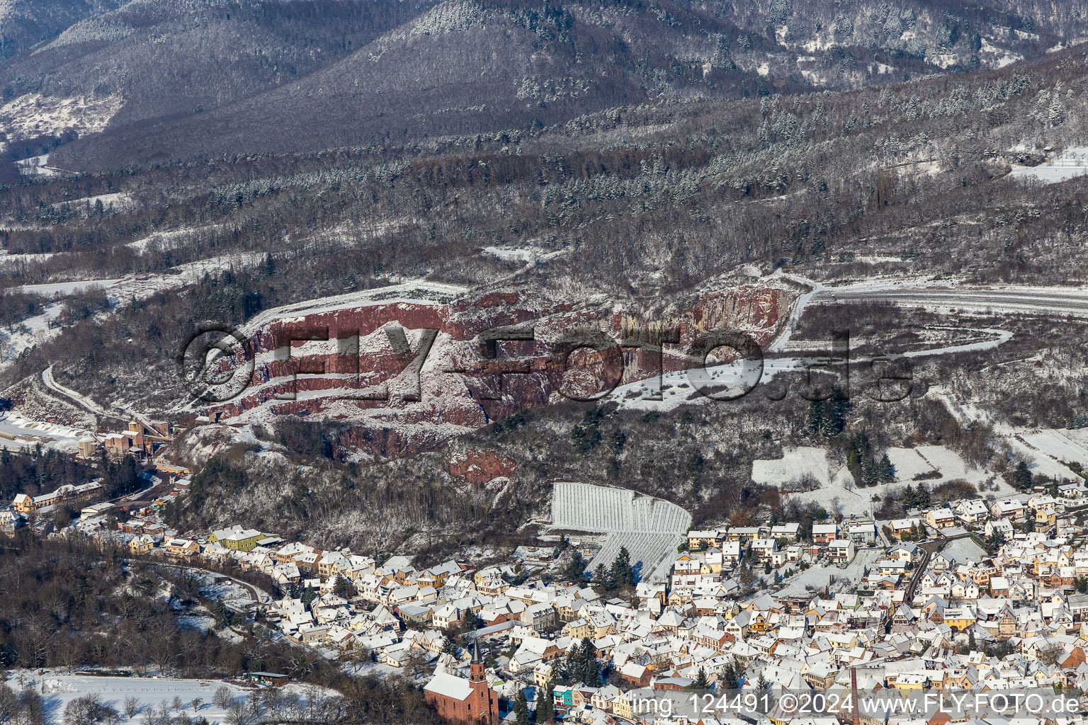 Winter aerial view in the snow of the Basalt-AG quarry in Albersweiler in the state Rhineland-Palatinate, Germany