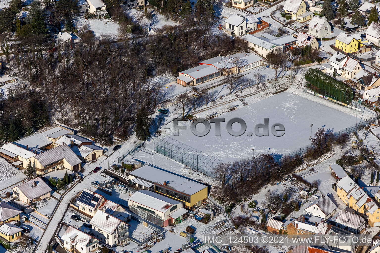 Winter aerial view in the snow of the sports field in Frankweiler in the state Rhineland-Palatinate, Germany