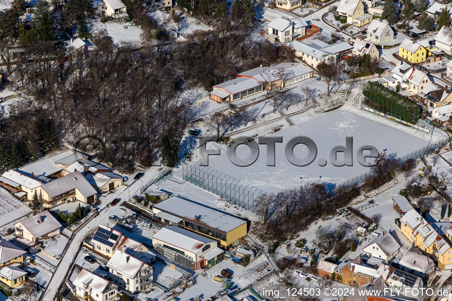 Winter aerial view in the snow of the sports field in Frankweiler in the state Rhineland-Palatinate, Germany