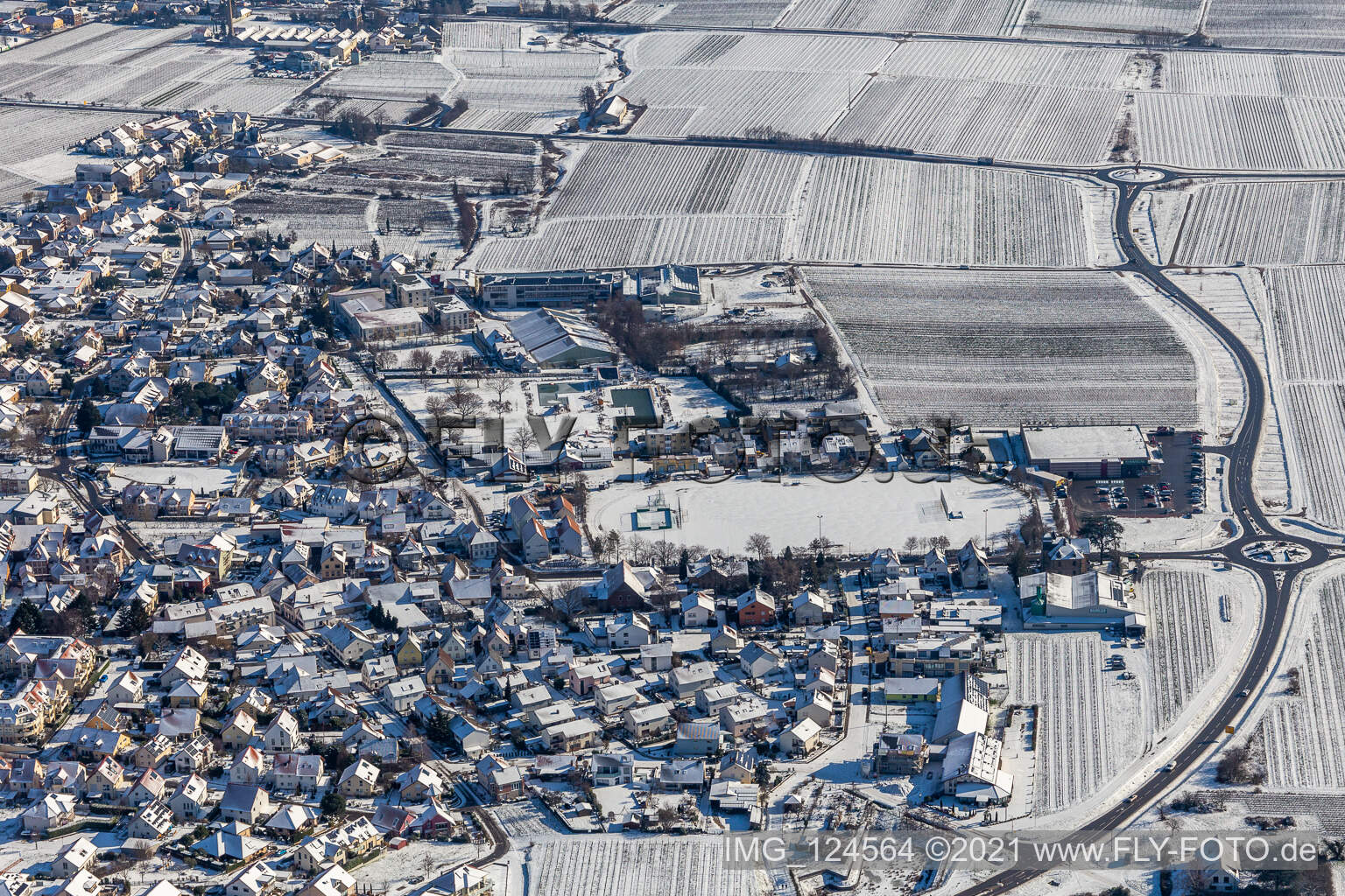 Winter aerial photo in the snow of the TUS Maikammer 1920 eV sports field in Maikammer in the state Rhineland-Palatinate, Germany