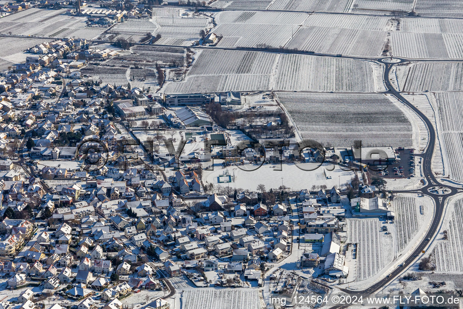 Winter aerial photo in the snow of the TUS Maikammer 1920 eV sports field in Maikammer in the state Rhineland-Palatinate, Germany