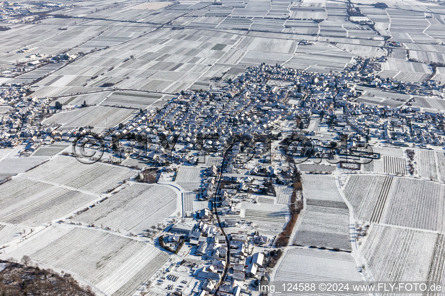 Wintry snowy village - view on the edge of agricultural fields and farmland in Diedesfeld in the state Rhineland-Palatinate