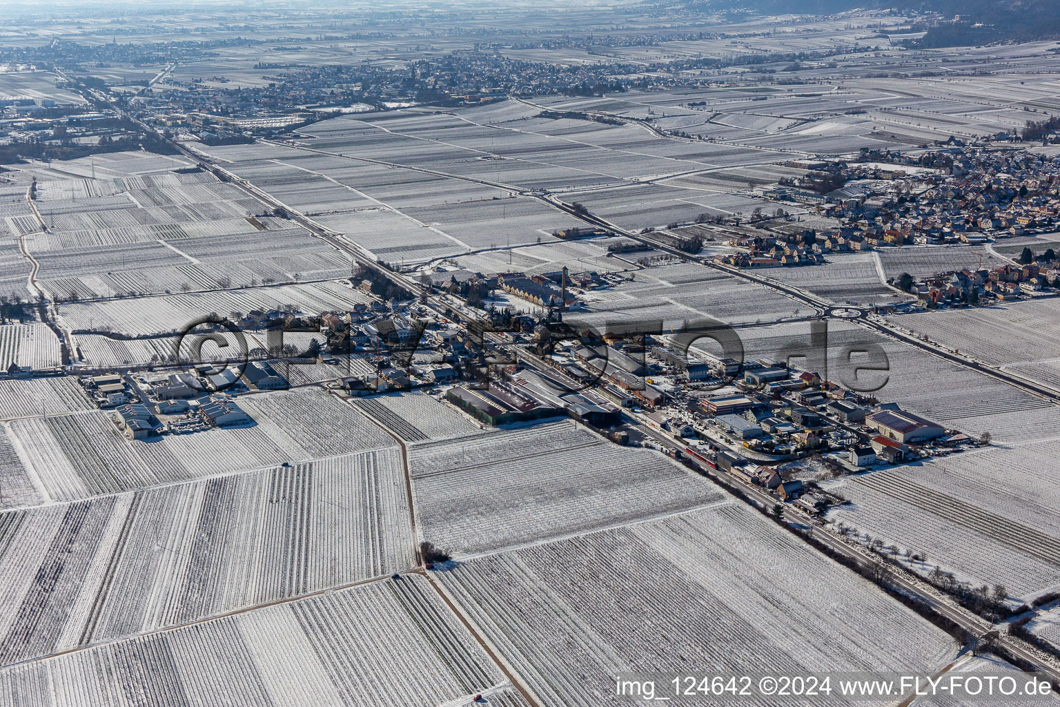 Winter aerial view in the snow industrial area Bordmühle in Kirrweiler in the state Rhineland-Palatinate, Germany