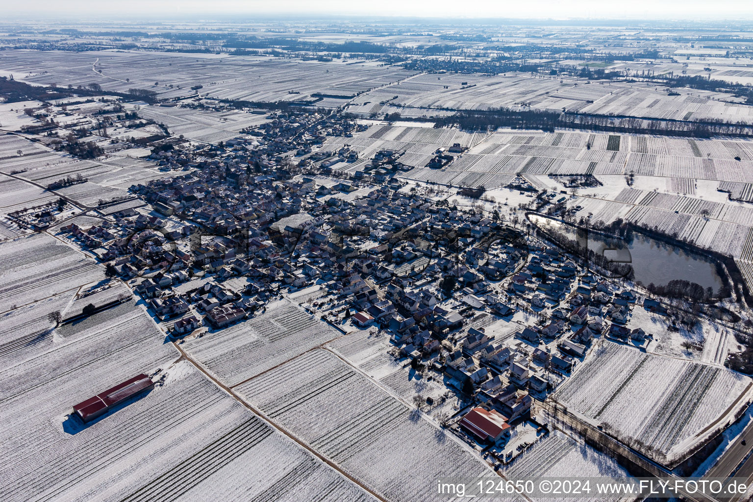 Winter aerial view in the snow with a castle pond in Kirrweiler in the state Rhineland-Palatinate, Germany