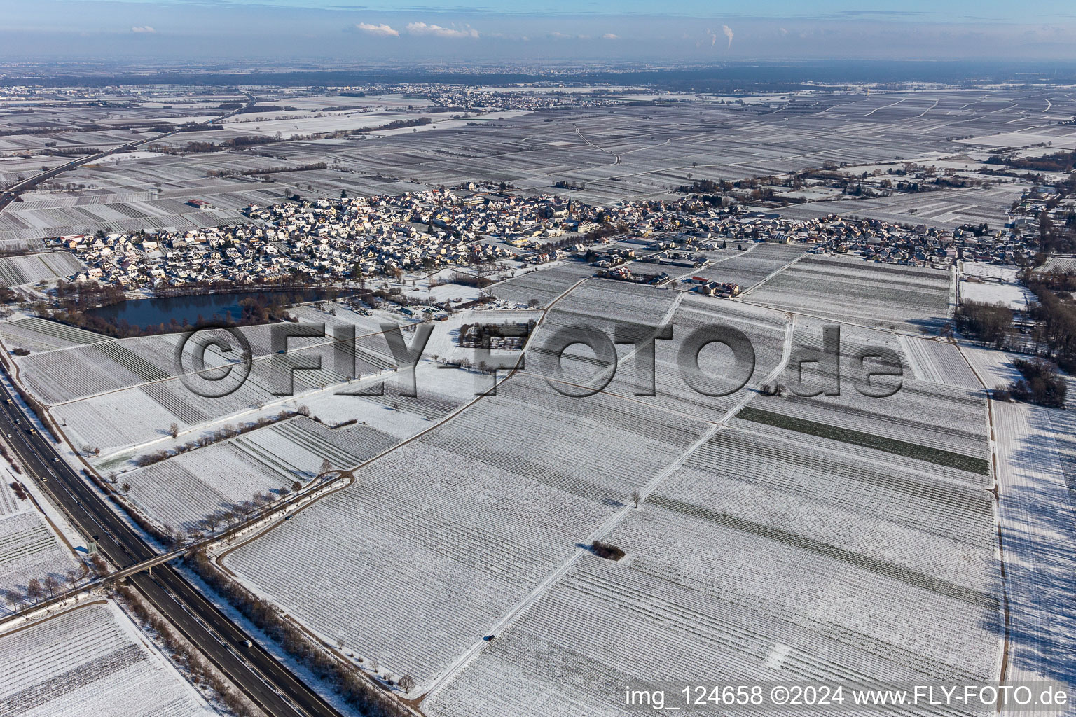 Aerial view of Winter aerial view in the snow with a castle pond in Kirrweiler in the state Rhineland-Palatinate, Germany