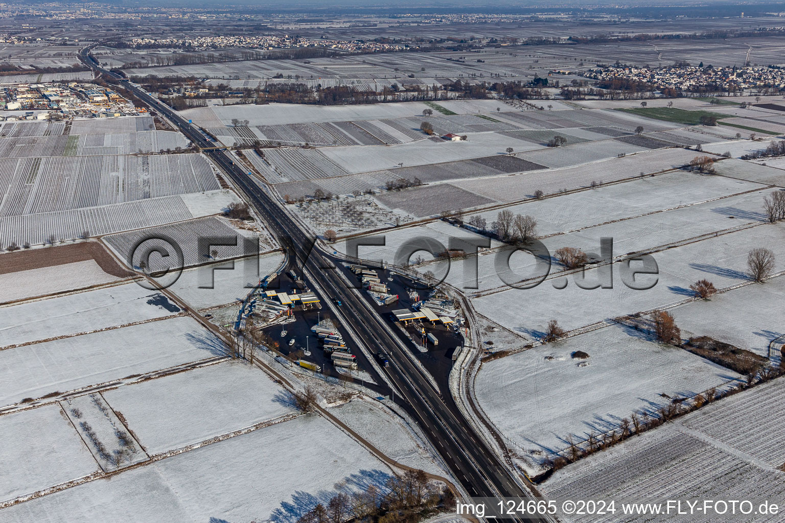 Wintry snowy motorway service area on the edge of the course of BAB highway Serways Pfaelzer Weinstrasse in Edesheim in the state Rhineland-Palatinate