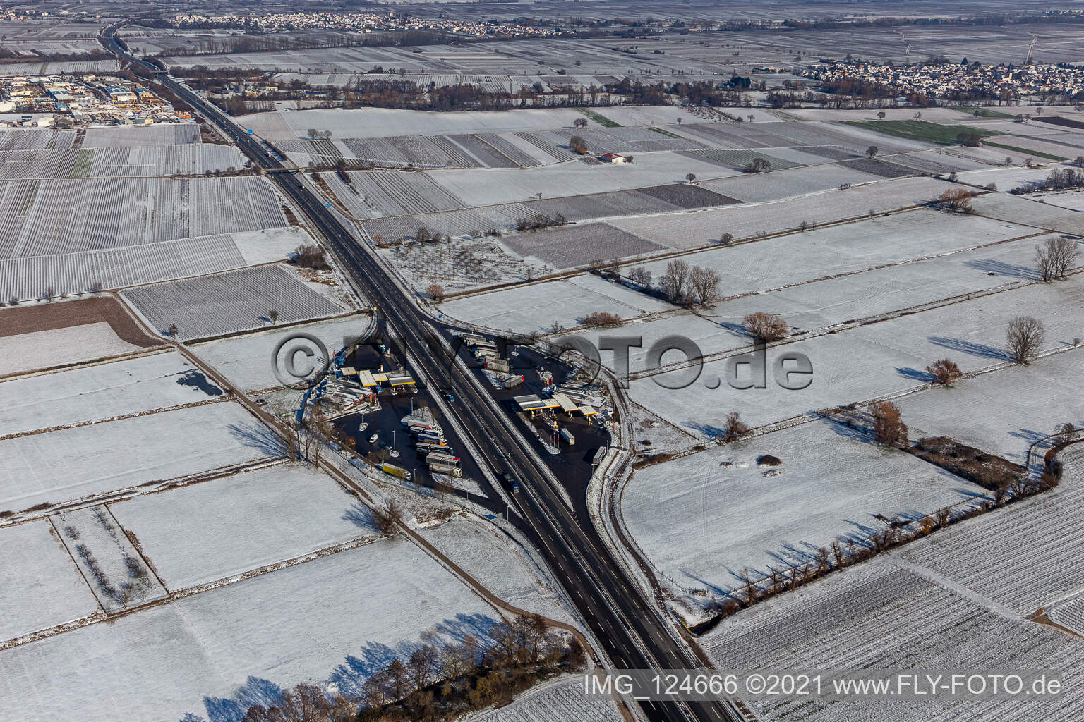 Winter aerial photograph in the snow of the motorway service station Pfälzer Weinstraße in Edesheim in the state Rhineland-Palatinate, Germany