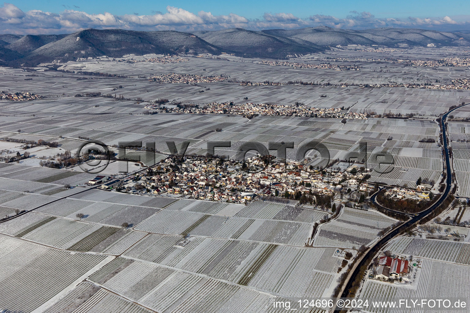 Aerial photograpy of Wintry snowy village - view on the edge of agricultural fields and farmland in Walsheim in the state Rhineland-Palatinate, Germany