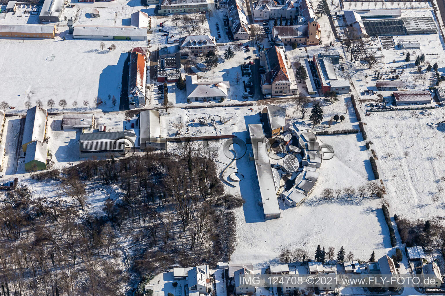 Winter aerial view in the snow of Jugendwerk St. Josef and Caritas Förderzentrum Laurentius und Paulus in the district Queichheim in Landau in der Pfalz in the state Rhineland-Palatinate, Germany