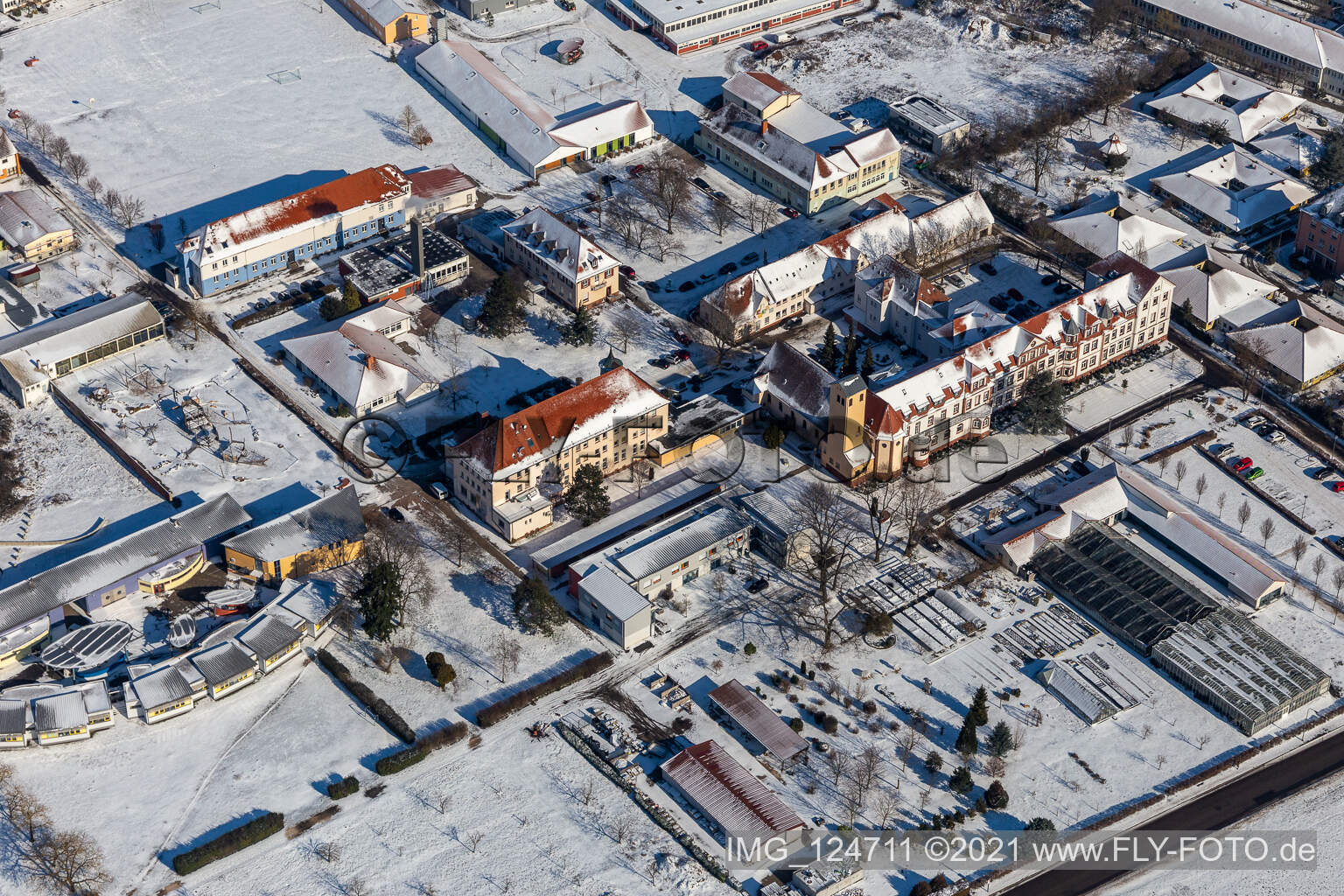 Aerial view of Wintry snowy buildings of the Childrens and Youth Home Jugendwerk St. Josef in the district Queichheim in Landau in der Pfalz in the state Rhineland-Palatinate, Germany