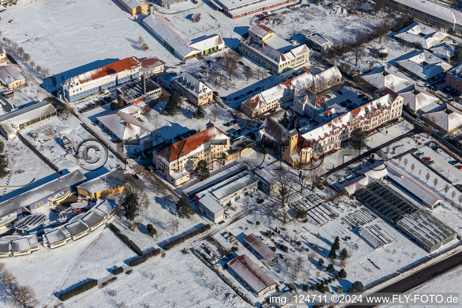 Aerial view of Wintry snowy buildings of the Childrens and Youth Home Jugendwerk St. Josef in the district Queichheim in Landau in der Pfalz in the state Rhineland-Palatinate, Germany