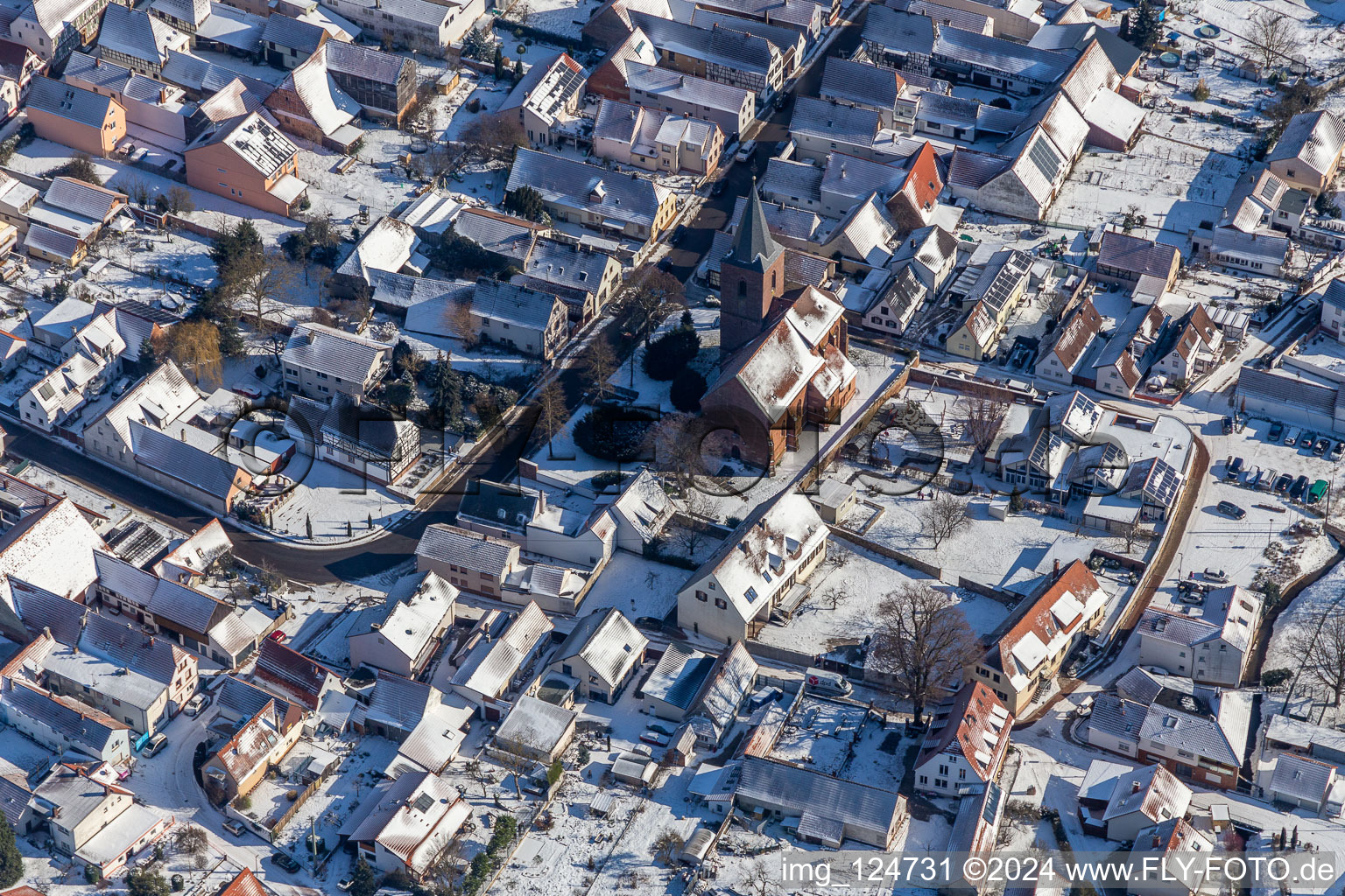 Winter aerial view in the snow of St. Michael Simultankirche in Rohrbach in the state Rhineland-Palatinate, Germany