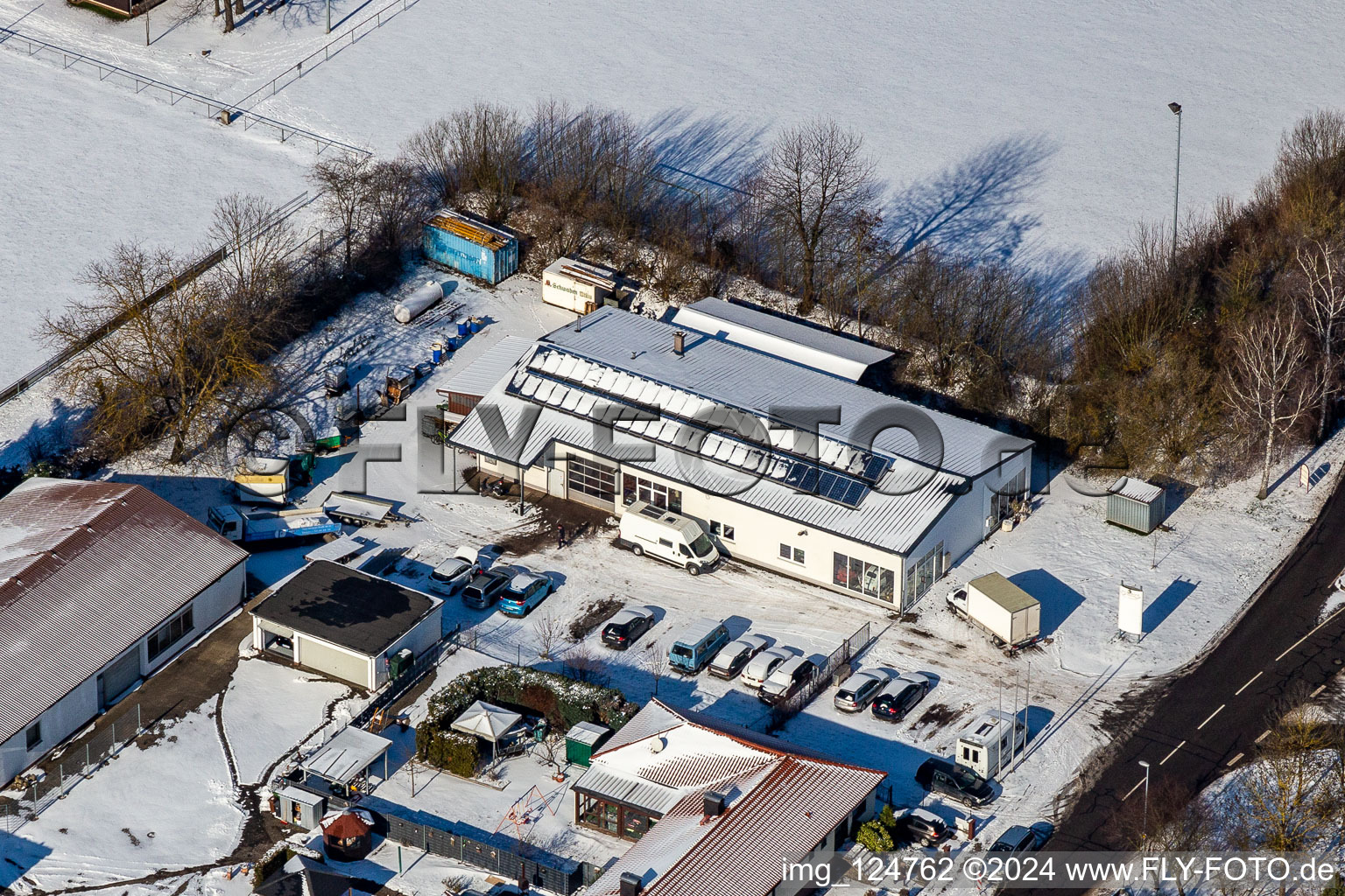 Winter aerial photo in the snow of car repair shop Peter Thürwächter in Winden in the state Rhineland-Palatinate, Germany