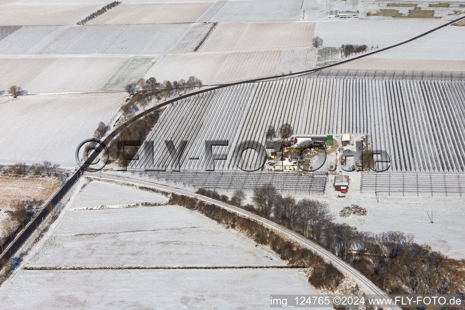 Winter aerial view in the snow of the Gensheimer asparagus and fruit farm in Steinweiler in the state Rhineland-Palatinate, Germany