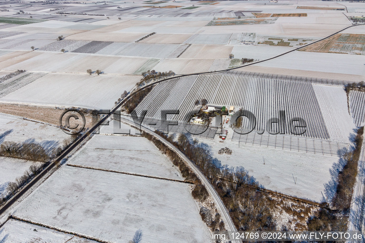 Aerial view of Winter aerial view in the snow of the Gensheimer asparagus and fruit farm in Steinweiler in the state Rhineland-Palatinate, Germany