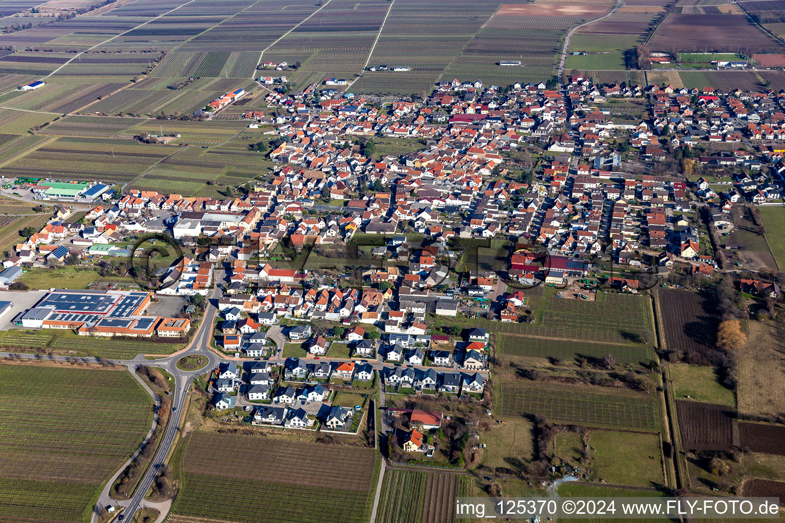 Aerial view of Village view on the edge of agricultural fields and land in Niederkirchen bei Deidesheim in the state Rhineland-Palatinate, Germany