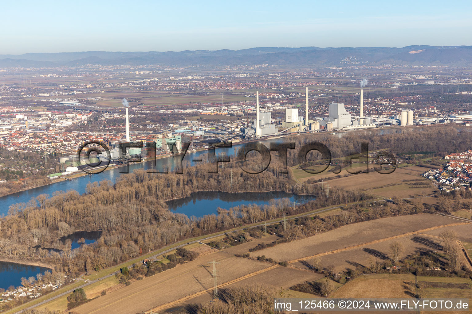 Power plants and exhaust towers of coal thermal power station Grosskraftwerk Mannheim AG at the shore of the Rhine river near Neckarau in Mannheim in the state Baden-Wurttemberg, Germany